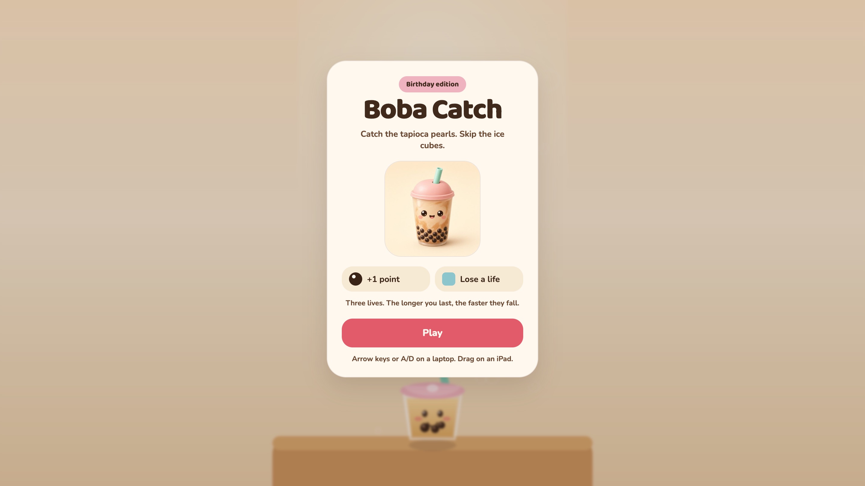 Boba Catch on a laptop, the start screen. A Birthday edition badge, the title, a smiling bubble tea cup, the two rules and a pink Play button over the blurred game.