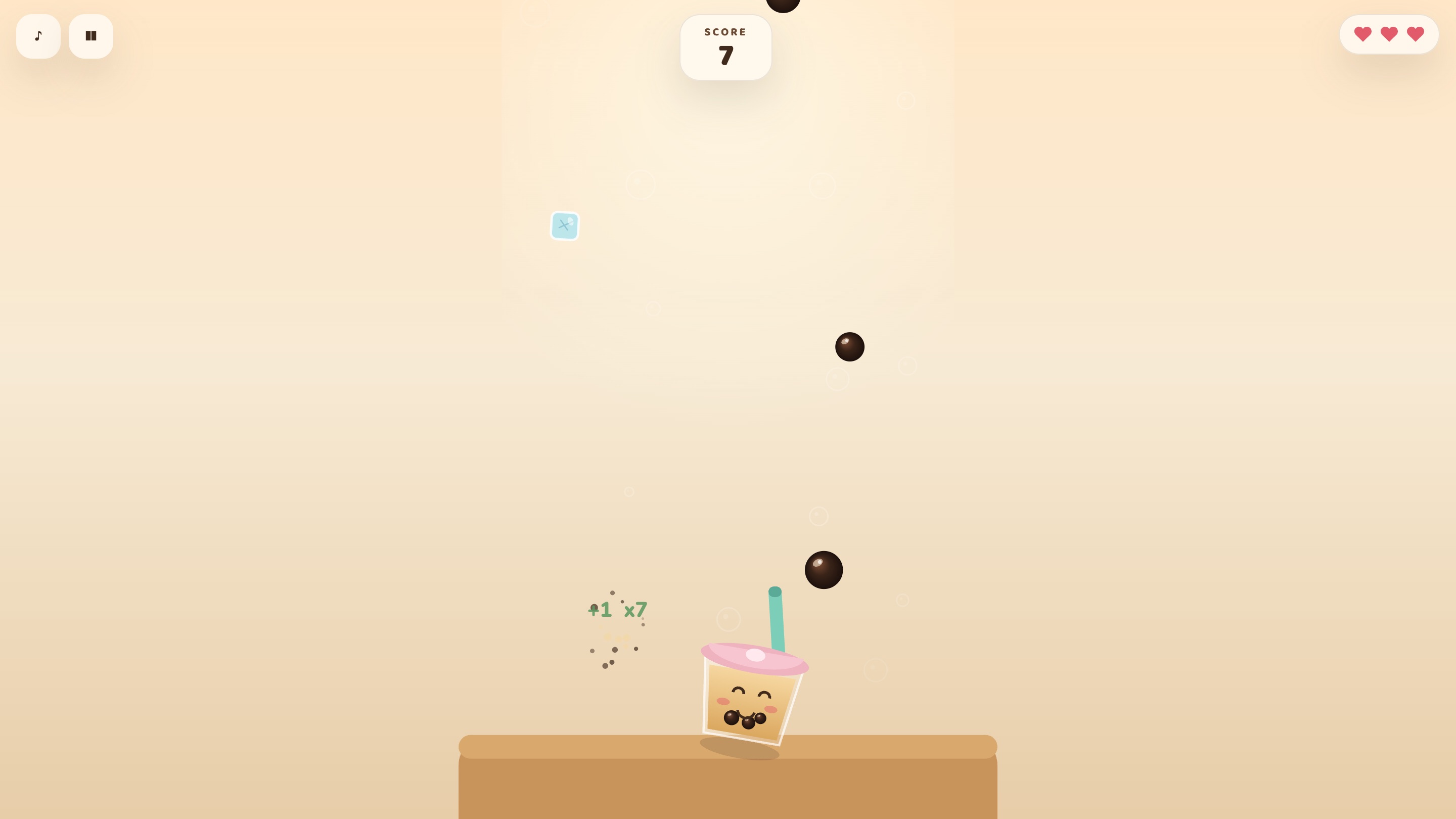 Laptop, playing. Pearls and an ice cube fall, the cup smiles as it catches a pearl with +1 x7 above it, the score of 7 sits at the top and three hearts sit in the top right corner.