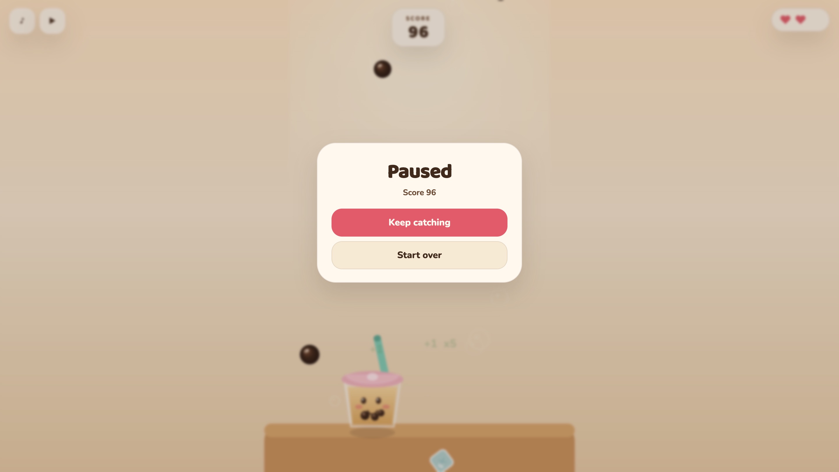Laptop, paused. A Paused card with the score, Keep catching and Start over, over the blurred game.